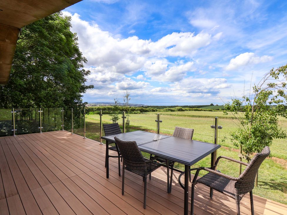 An outdoor area with a table and chairs at Freedom Lodge @ Summerfield Farm, Whitby