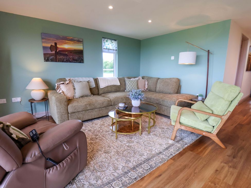 A living room with a sofa and coffee table at Freedom Lodge @ Summerfield Farm in Whitby