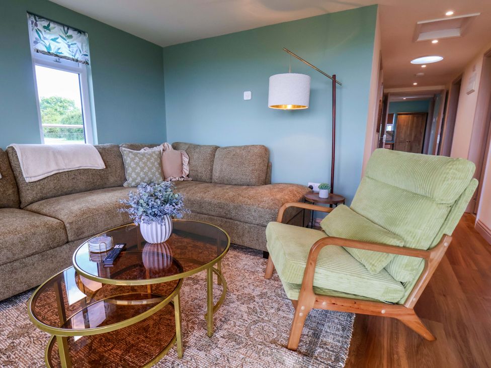A living room with a sofa and coffee table at Freedom Lodge @ Summerfield Farm in Whitby