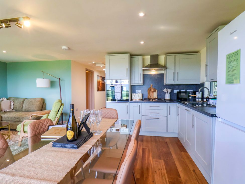 A kitchen with dining area and sofa at Freedom Lodge @ Summerfield Farm, Whitby