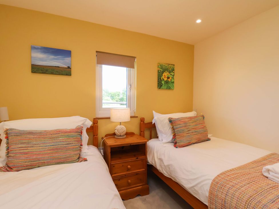 A bedroom with two beds and a window at Freedom Lodge @ Summerfield Farm, Whitby
