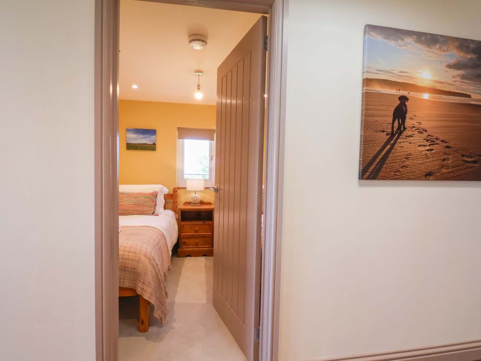 A bedroom with a bed and nightstand at Freedom Lodge @ Summerfield Farm, Whitby