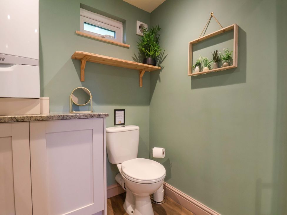 A bathroom with a toilet and sink at Freedom Lodge @ Summerfield Farm in Whitby