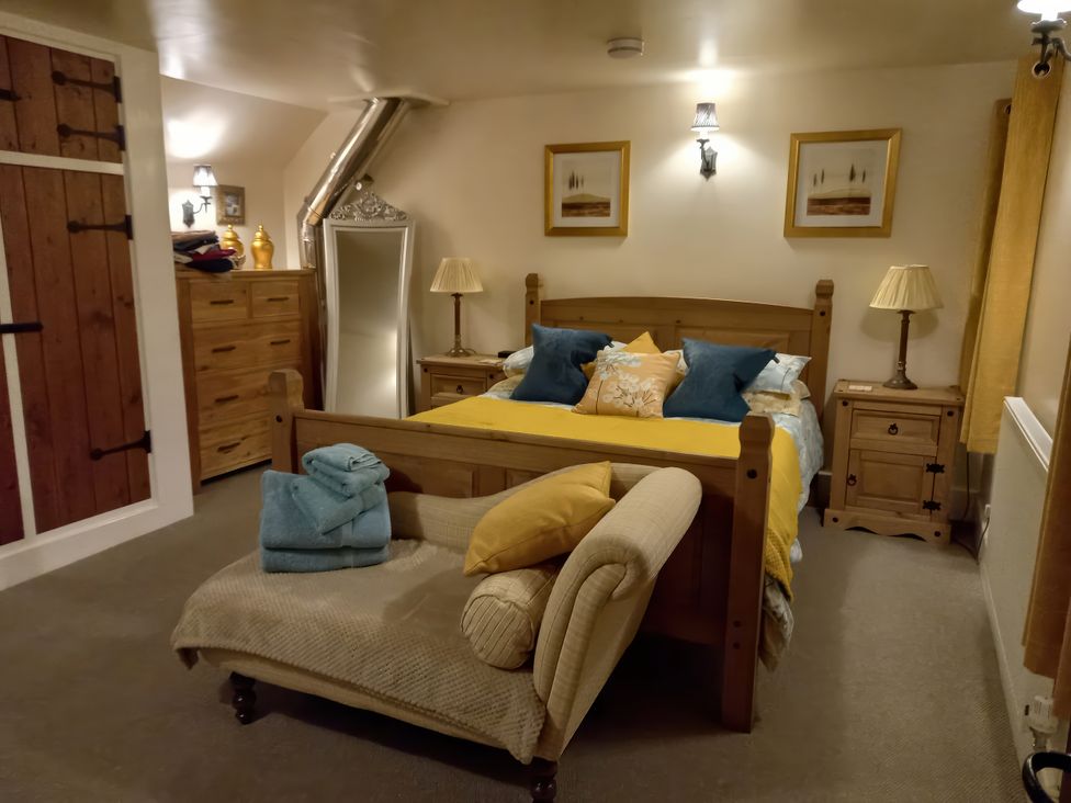 A bedroom with a bed and chest of drawers at Trelake Cottage 