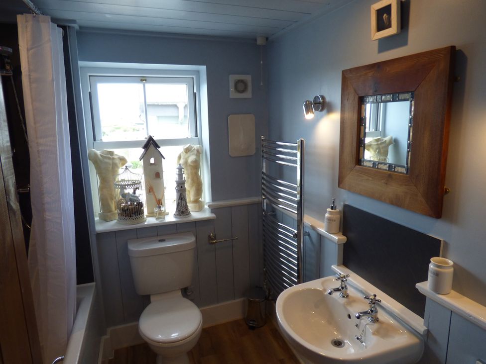 A bathroom with a toilet and sink at Trelake Cottage