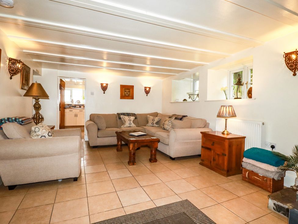 A living room with two sofas and a coffee table at Trelake Cottage in Tintagel