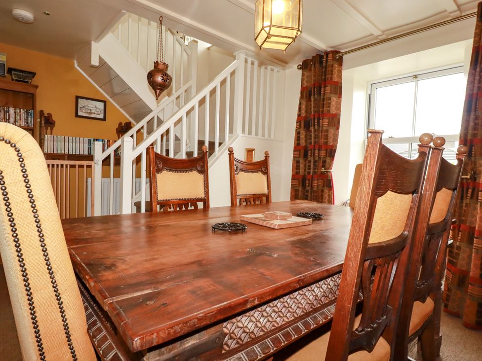 A dining room with a table and chairs at Trelake Cottage in Tintagel