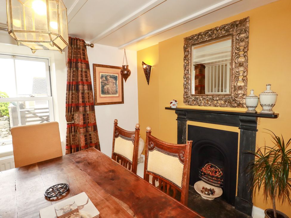 A dining room with a table and chairs at Trelake Cottage in Tintagel