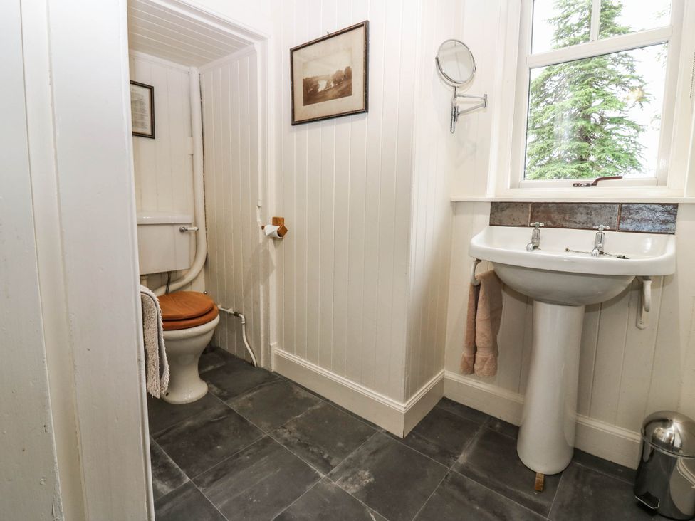 A bathroom with a toilet and sink at Gardener’s cottage in Stanley