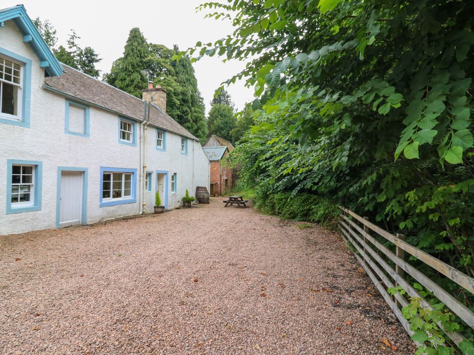 An outdoor area with a house and seating at Gardener’s cottage in Stanley