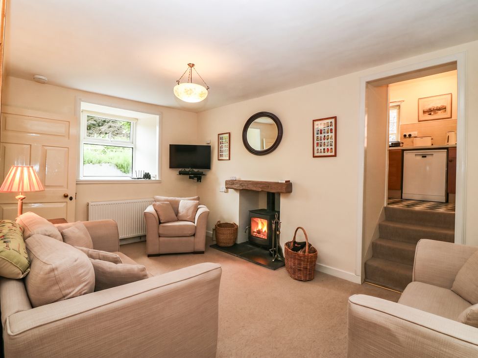 A living room with sofas and a fireplace at Gardener’s cottage in Stanley