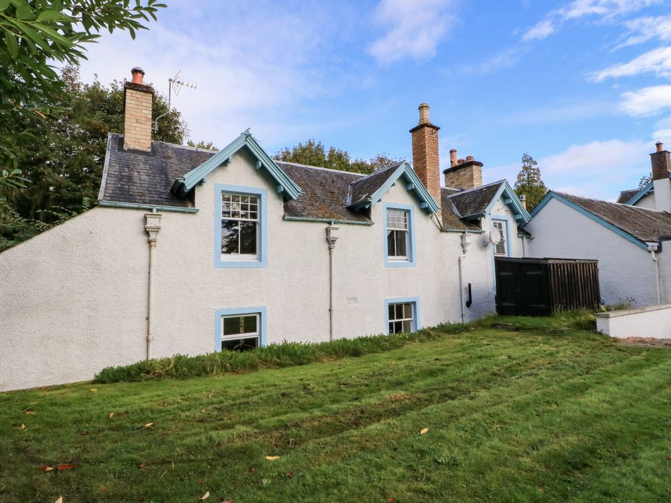 A house with multiple windows and a yard at Gardener’s cottage in Stanley