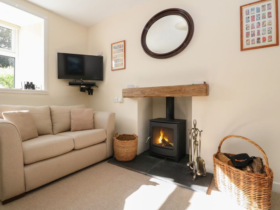 A living room with a sofa and fireplace at Gardener’s cottage in Stanley