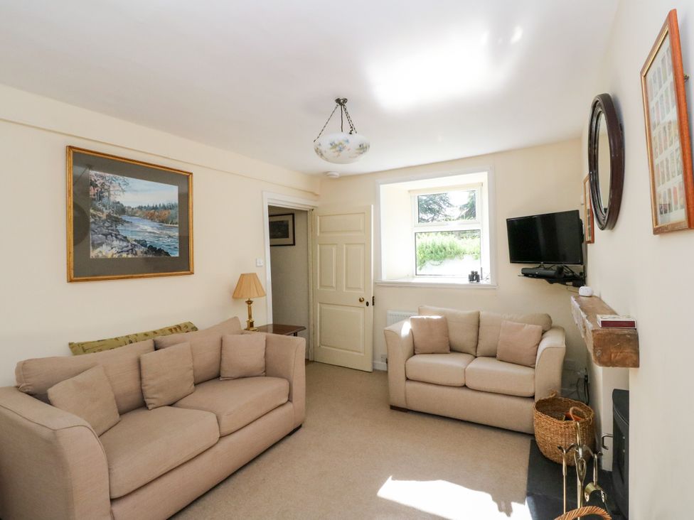A living room with two sofas and a television at Gardener’s cottage in Stanley