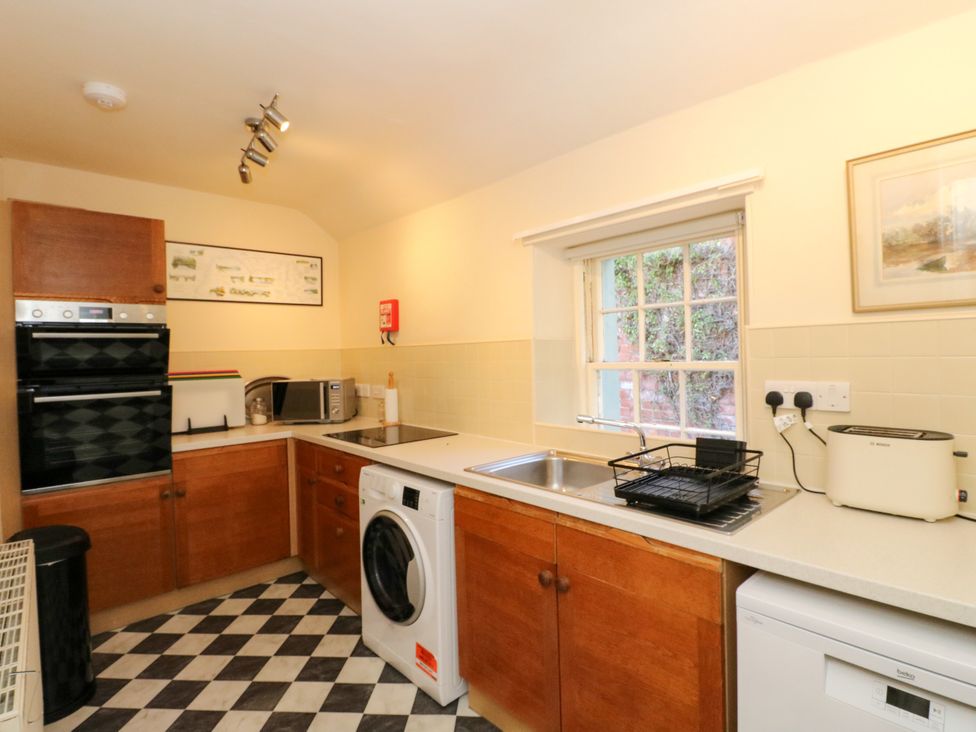 A kitchen with appliances and cabinetry at Gardener’s cottage in Stanley