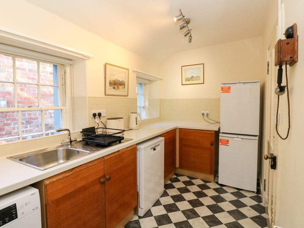 A kitchen with a sink and refrigerator at Gardener’s cottage in Stanley
