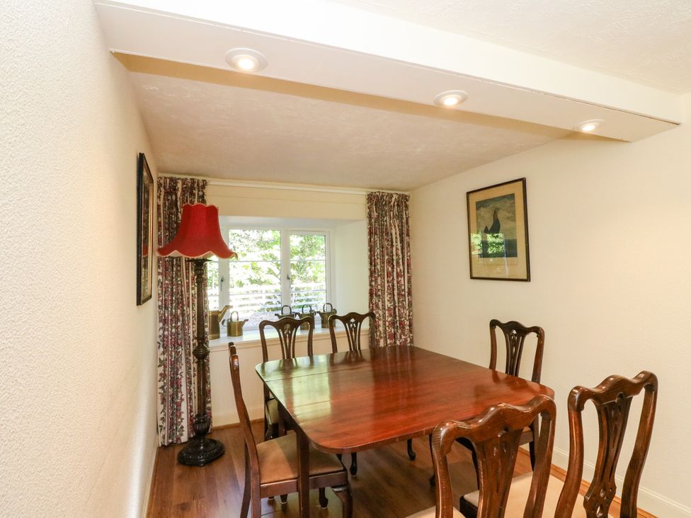 A dining room with a wooden table and chairs at Gardener’s cottage in Stanley