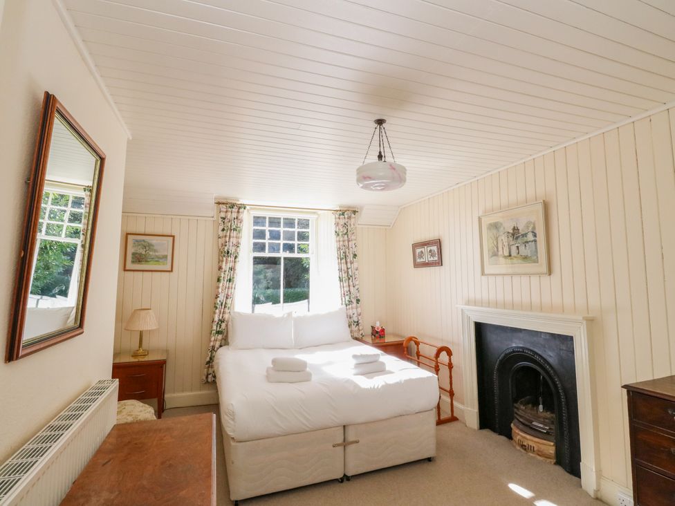 A bedroom with a bed and a window at Gardener’s cottage in Stanley