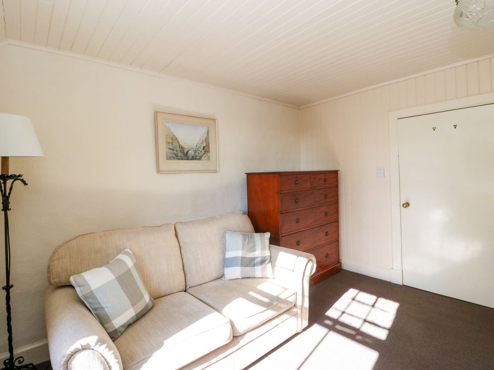 A living room with a sofa and a chest of drawers at Gardener’s cottage in Stanley