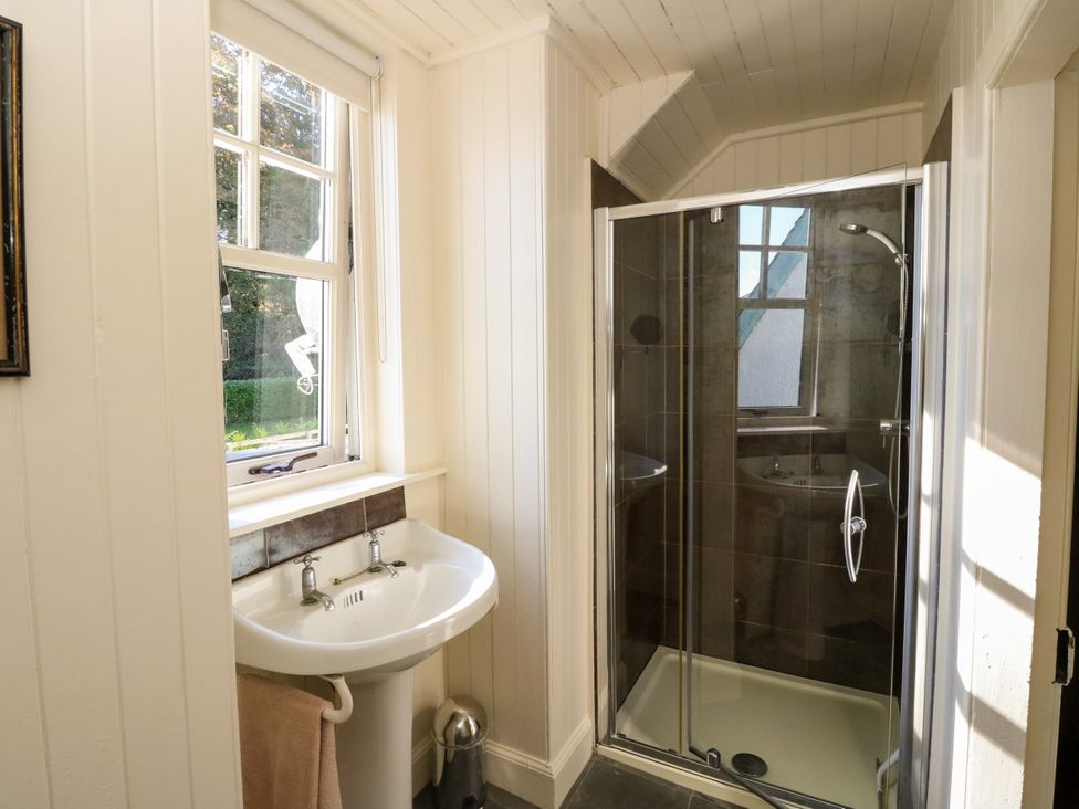 A bathroom with a sink and a shower at Gardener’s cottage in Stanley