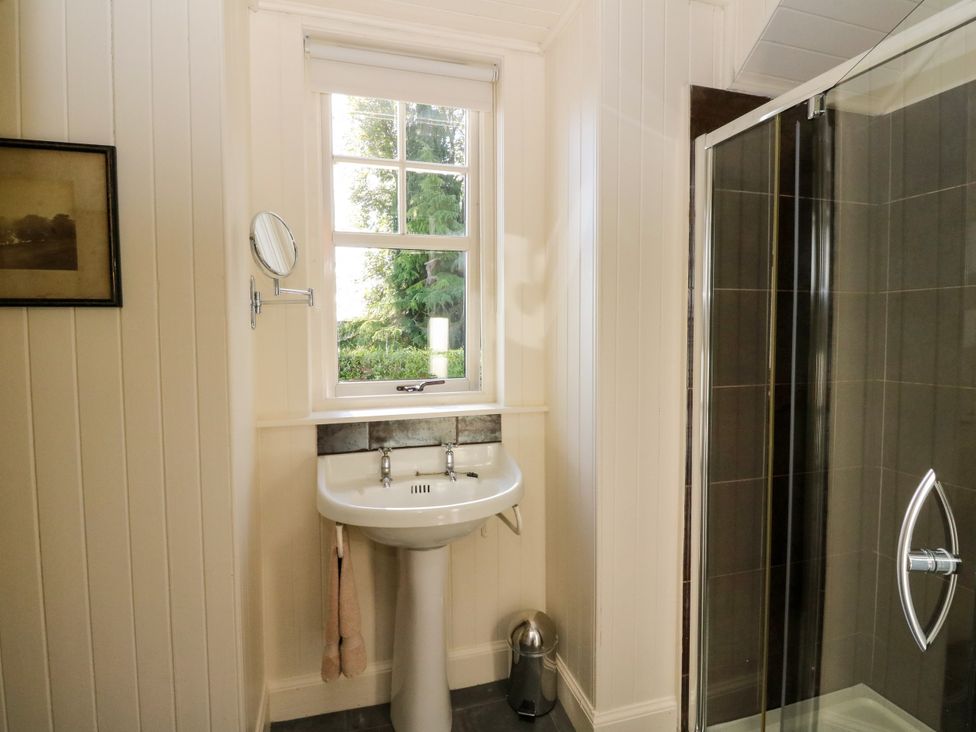 A bathroom with sink and shower at Gardener’s cottage in Stanley