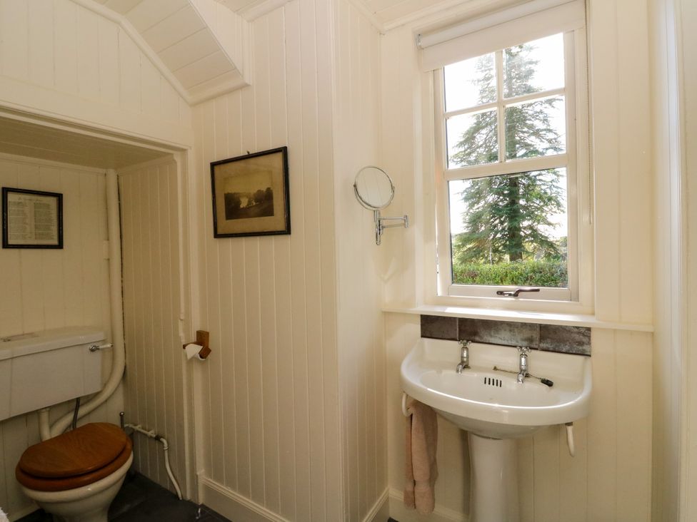 A bathroom with a sink and toilet at Gardener’s cottage in Stanley