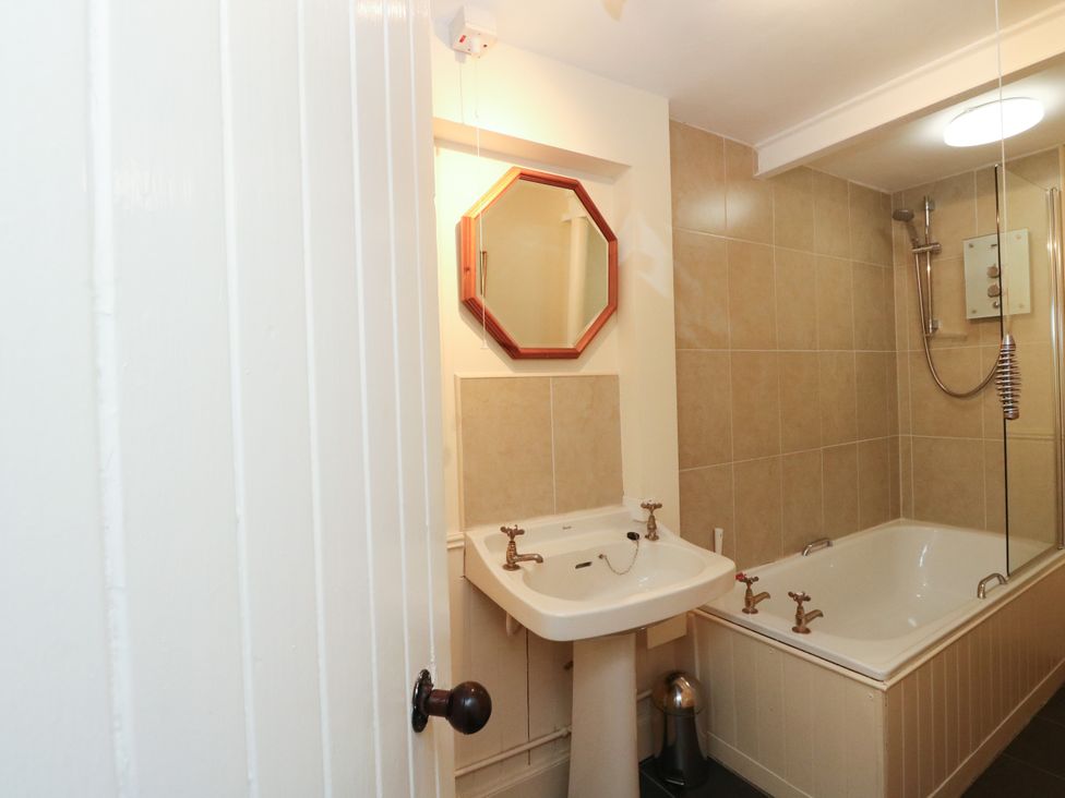 A bathroom with a sink and bathtub at Gardener’s cottage in Stanley