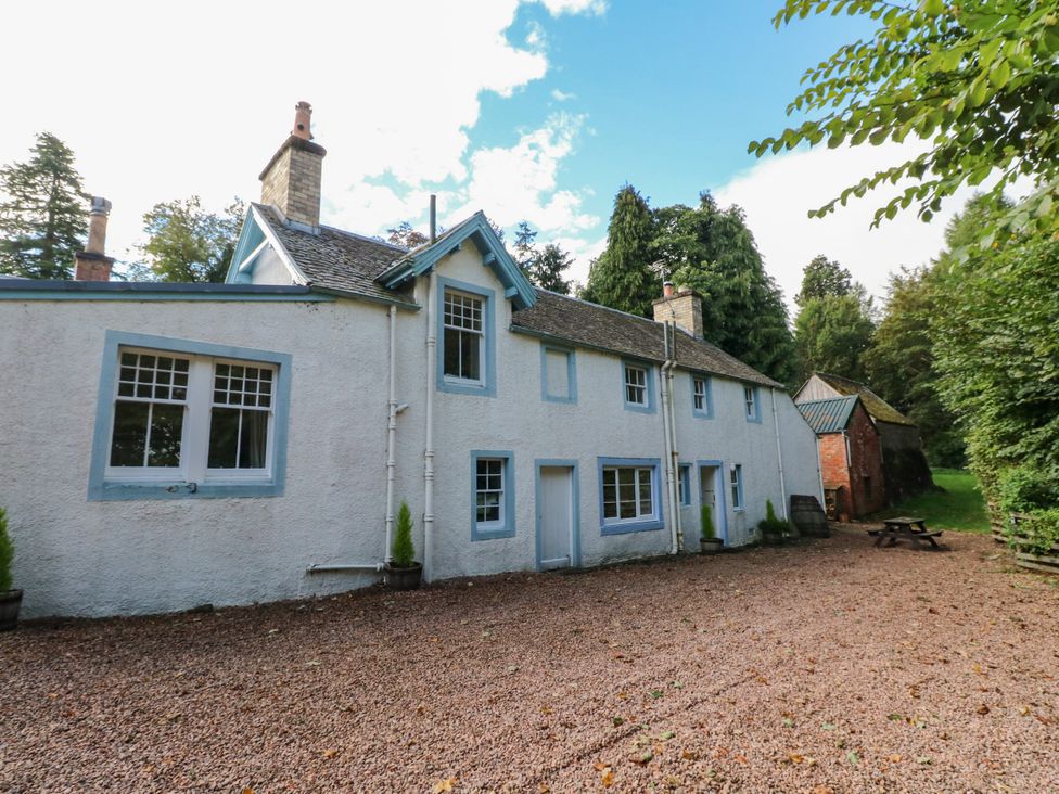 A house with external features and trees at Gardener’s cottage in Stanley