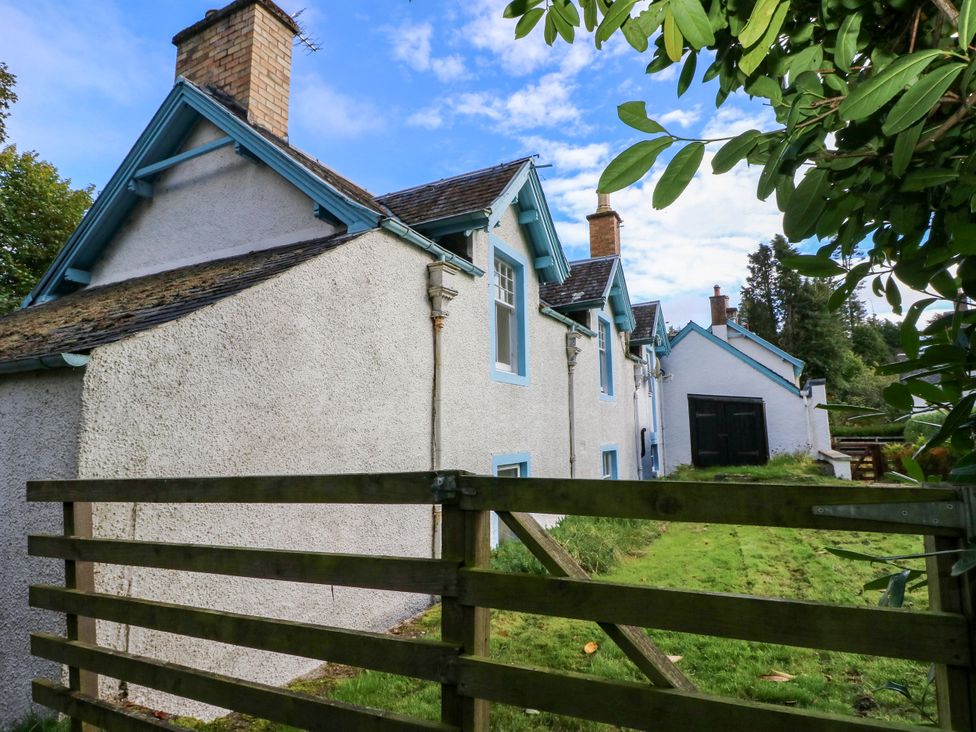 A side view of a house with a fence at Gardener’s cottage in Stanley