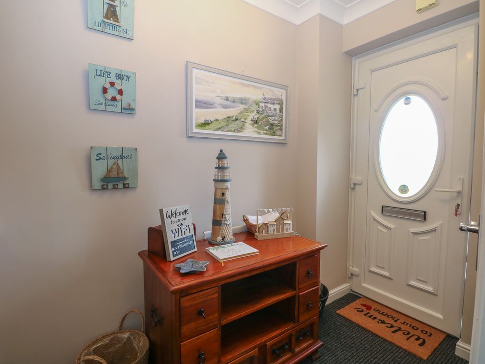 A hallway with a wooden table and decorations at The Willows 
