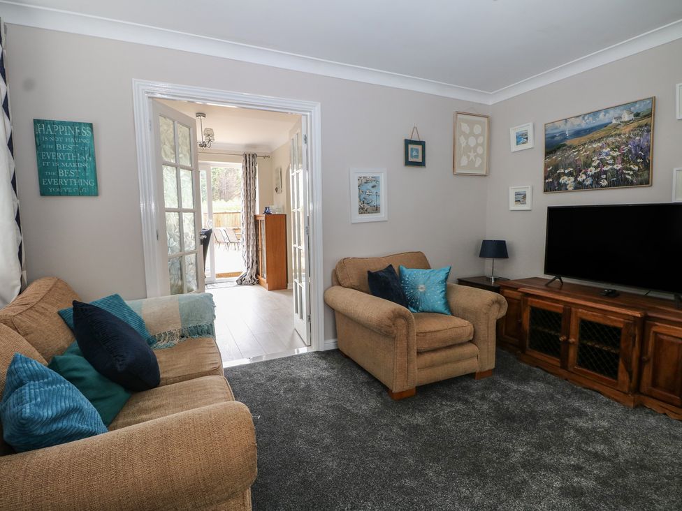 A living room with a sofa and television at The Willows