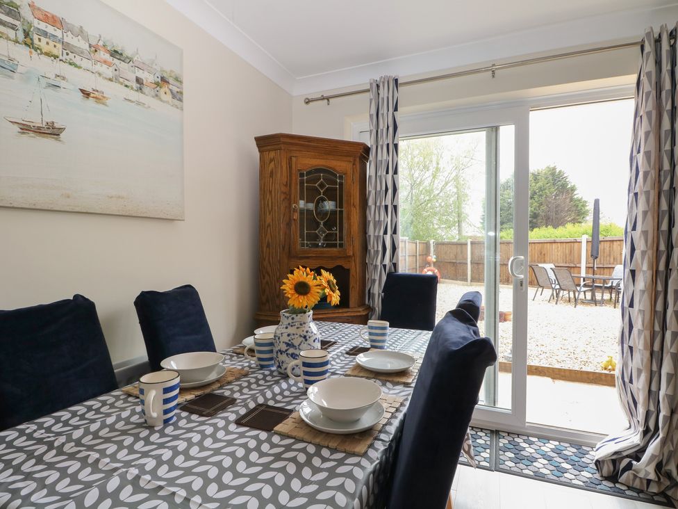 A dining room with a table set for meals at The Willows in 