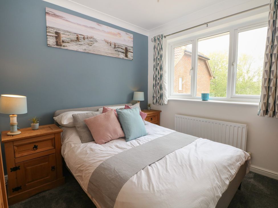 A bedroom with a bed and nightstands at The Willows in 