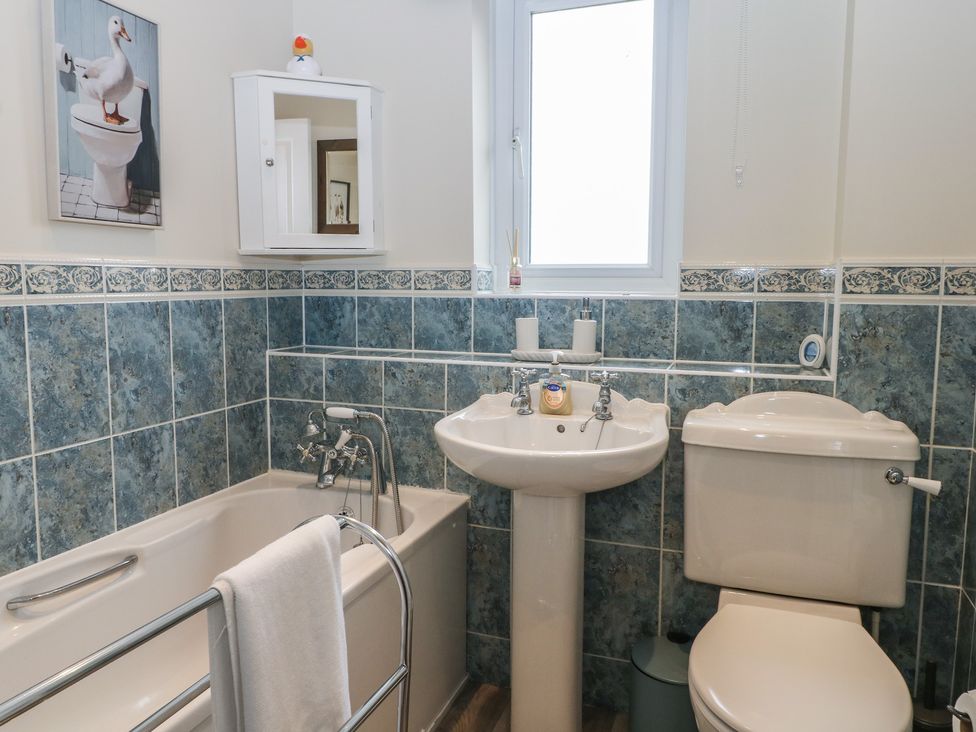 A bathroom with a bathtub, sink, and toilet at The Willows in 