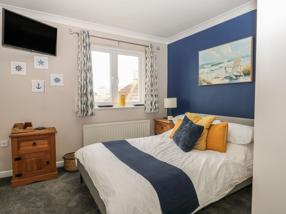 A bedroom with a bed and a TV at The Willows