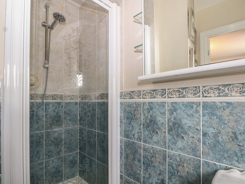 A bathroom with a shower and tiles at The Willows
