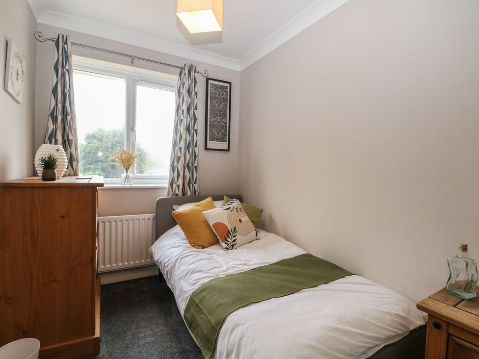A bedroom with a bed and a window at The Willows