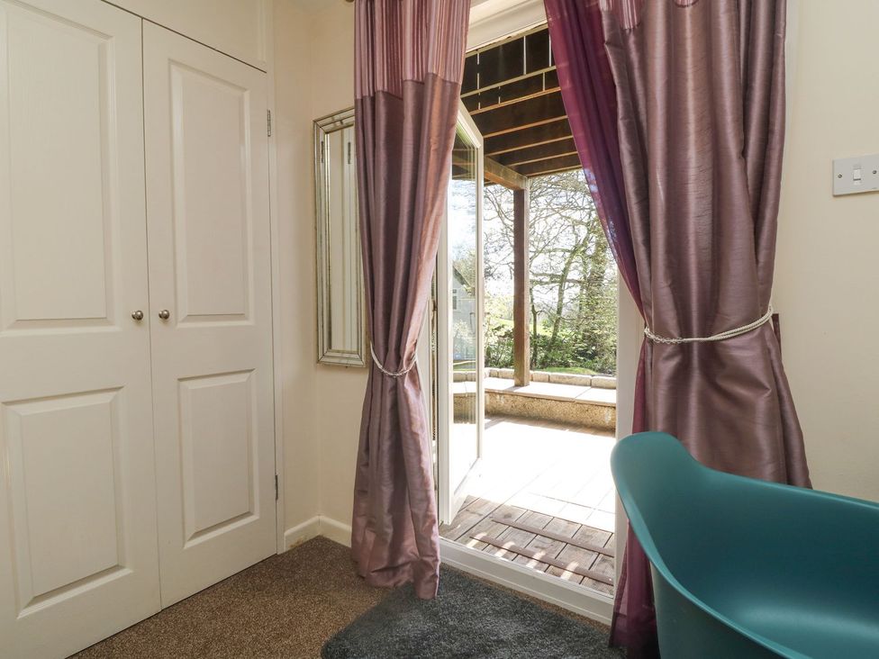 An indoor area with curtains and double doors at Honeycombe Lodge