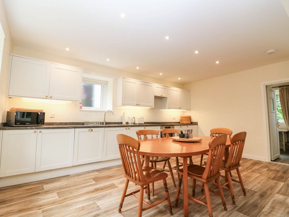 A kitchen with a dining table and chairs at West House in Perth