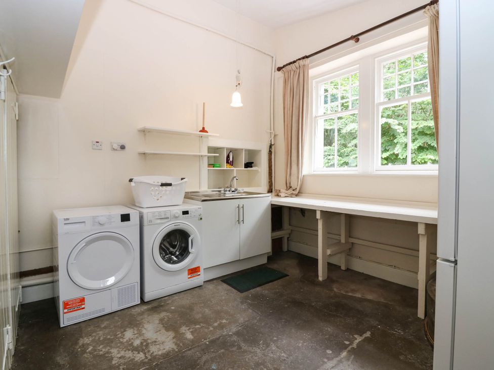 A utility room with a washing machine and a dryer at West House in Perth