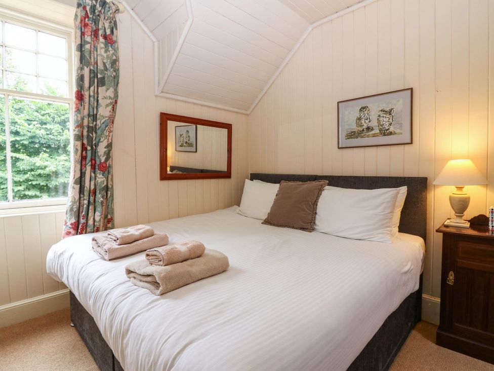 A bedroom with a bed and towels at West House in Perth