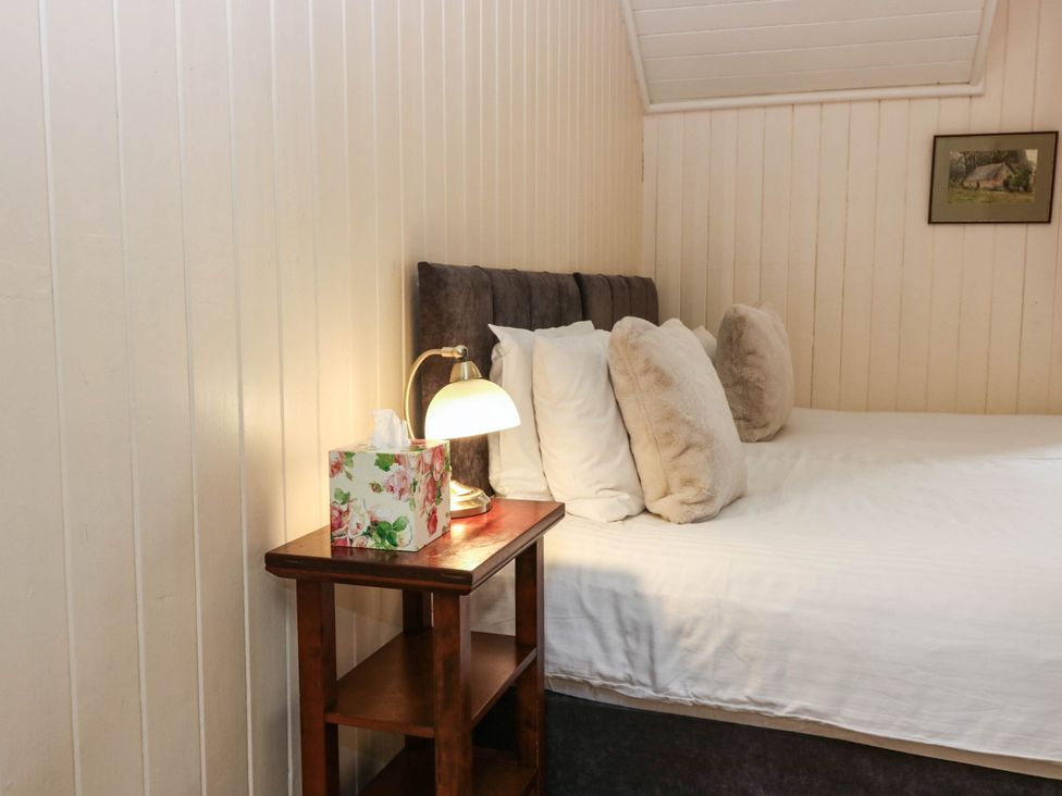 A bedroom with a bed and nightstand at West House in Perth
