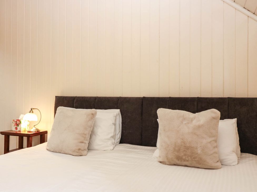 A bedroom with a bed and lamp at West House in Perth