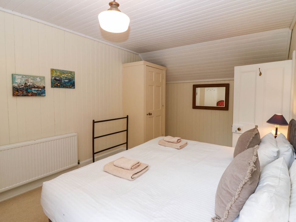 A bedroom with a bed and towels at West House in Perth
