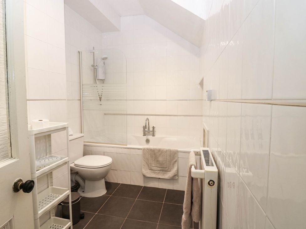 A bathroom with a bathtub and toilet at West House in Perth
