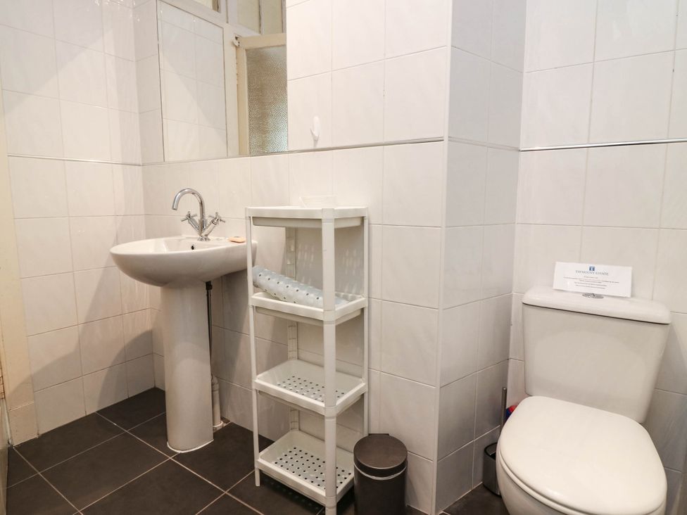 A bathroom featuring a sink, toilet, and shelf at West House in Perth