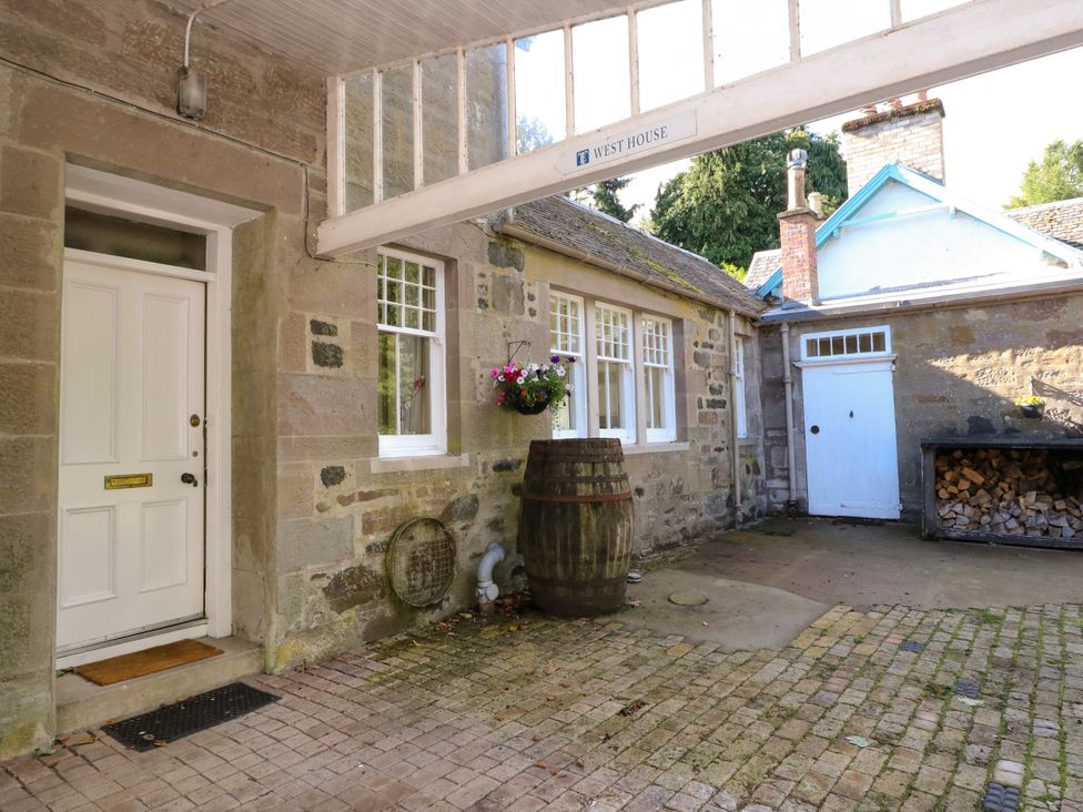 An outdoor area with a door and barrel at West House Stanley