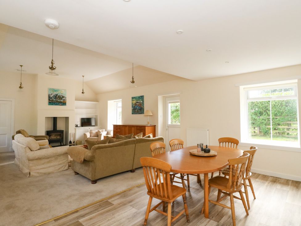 A living room with a sofa and dining table at West House in Stanley