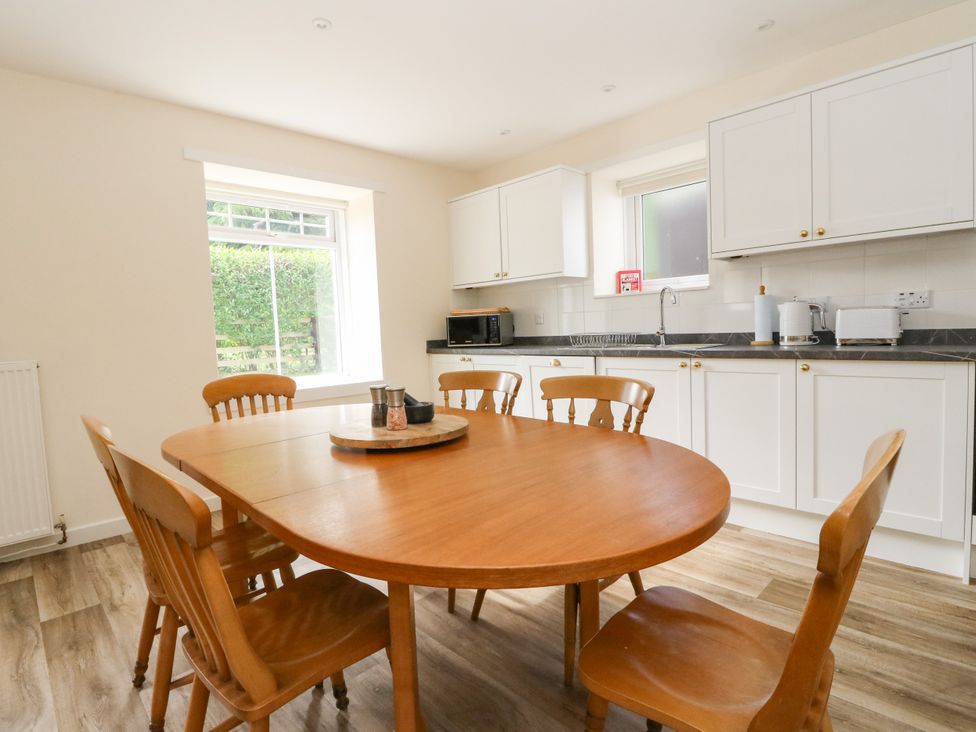 A kitchen with a dining table and chairs at West House in Stanley