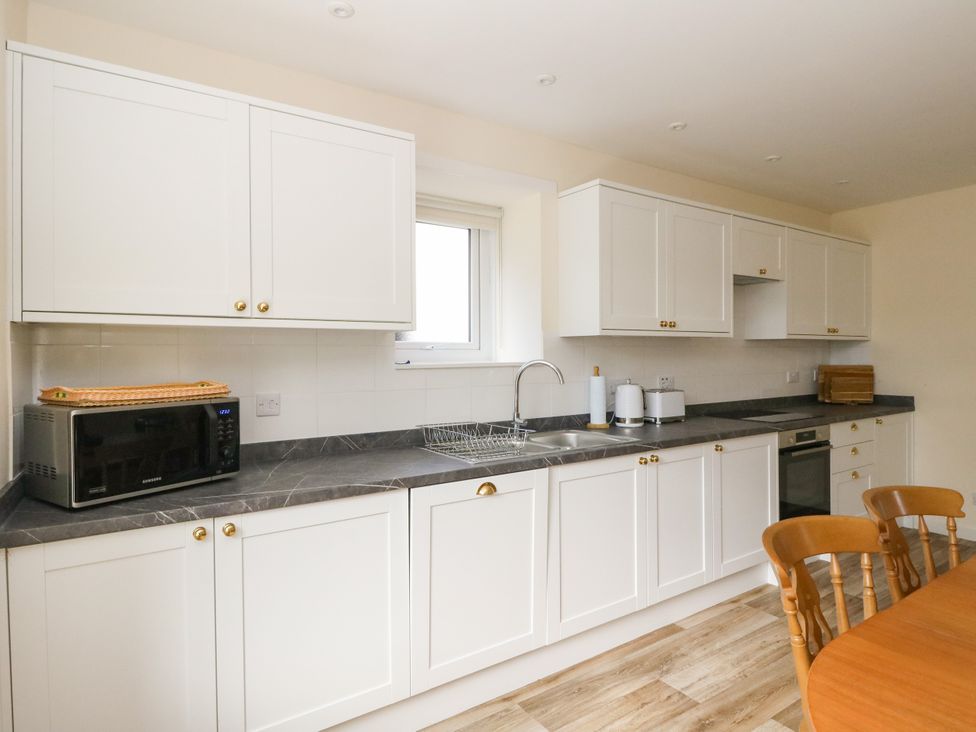 A kitchen with cabinets and appliances at West House in Stanley